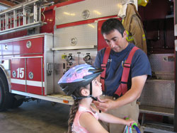 fireman fitting helmet on child
